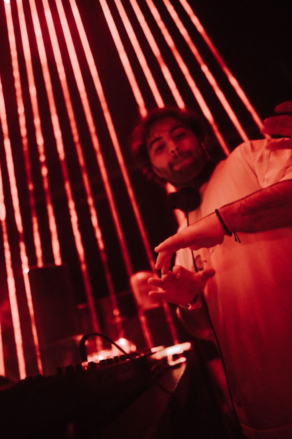 A DEEN smiling under red lights